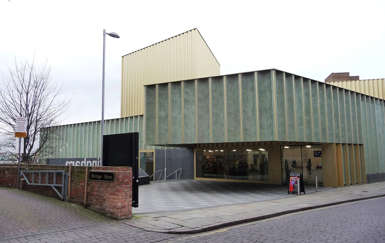 The green and gold exterior of Nottingham Contemporary beside Weekday Cross