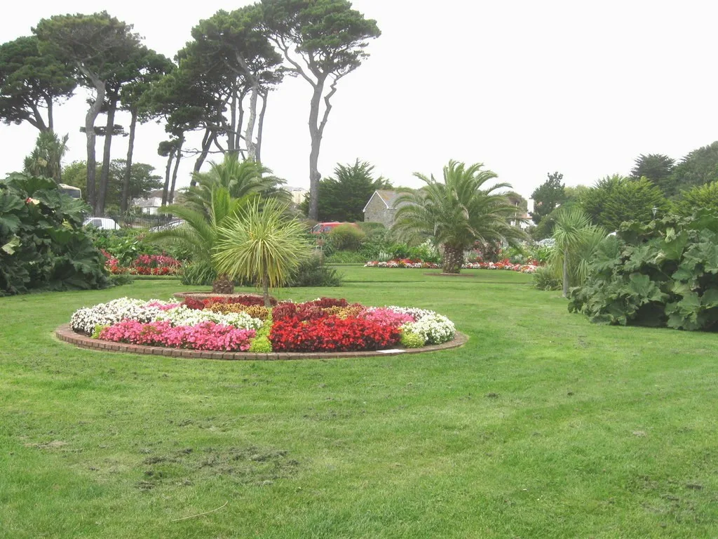 Colourful circular flower bed, lawns and palms in Queen Mary Gardens, Falmouth