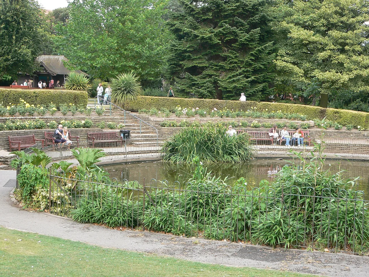 A planted pond with paths and seating in Grosvenor Park