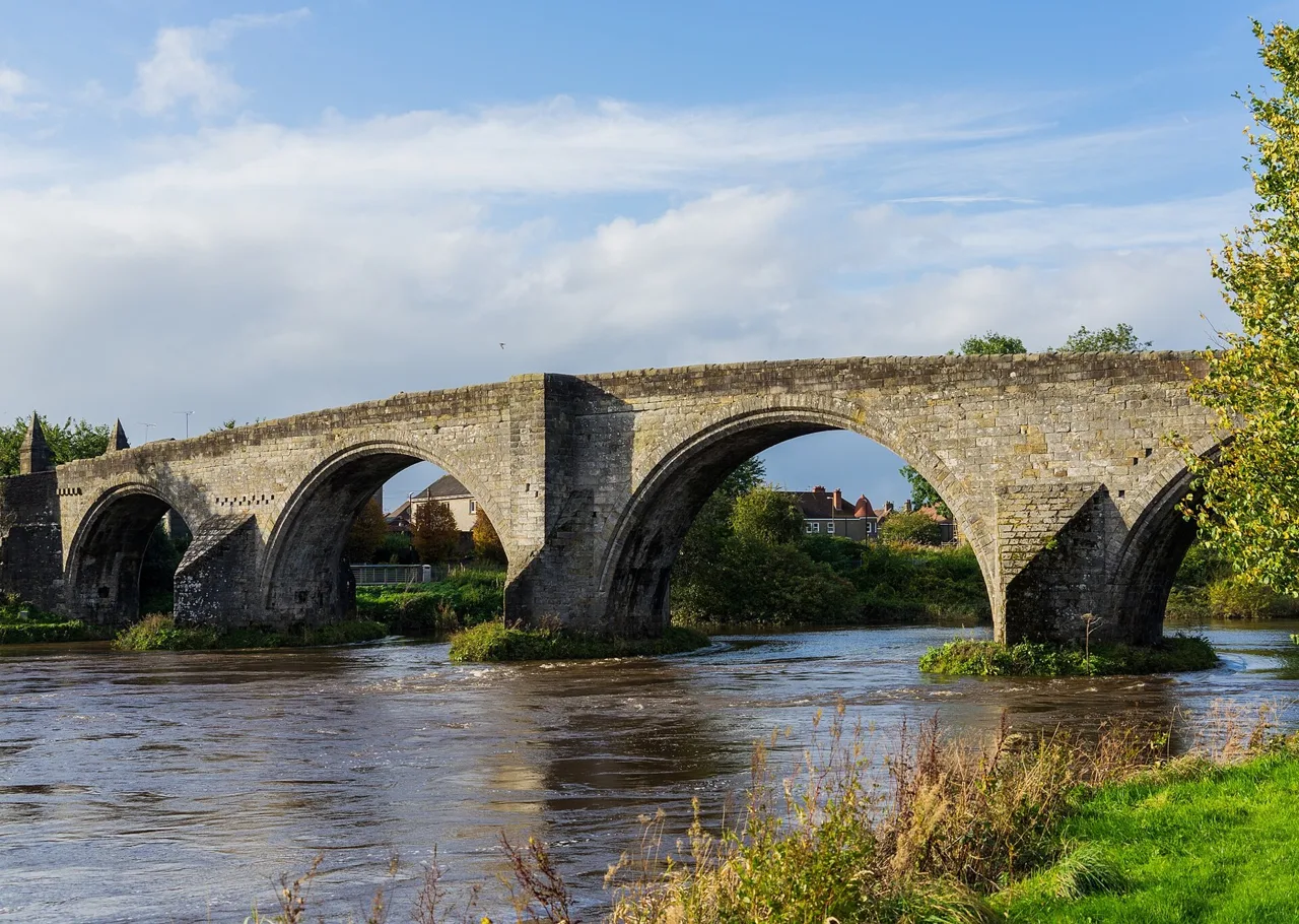 Stone arches of Stirling Old Bridge over the River Forth