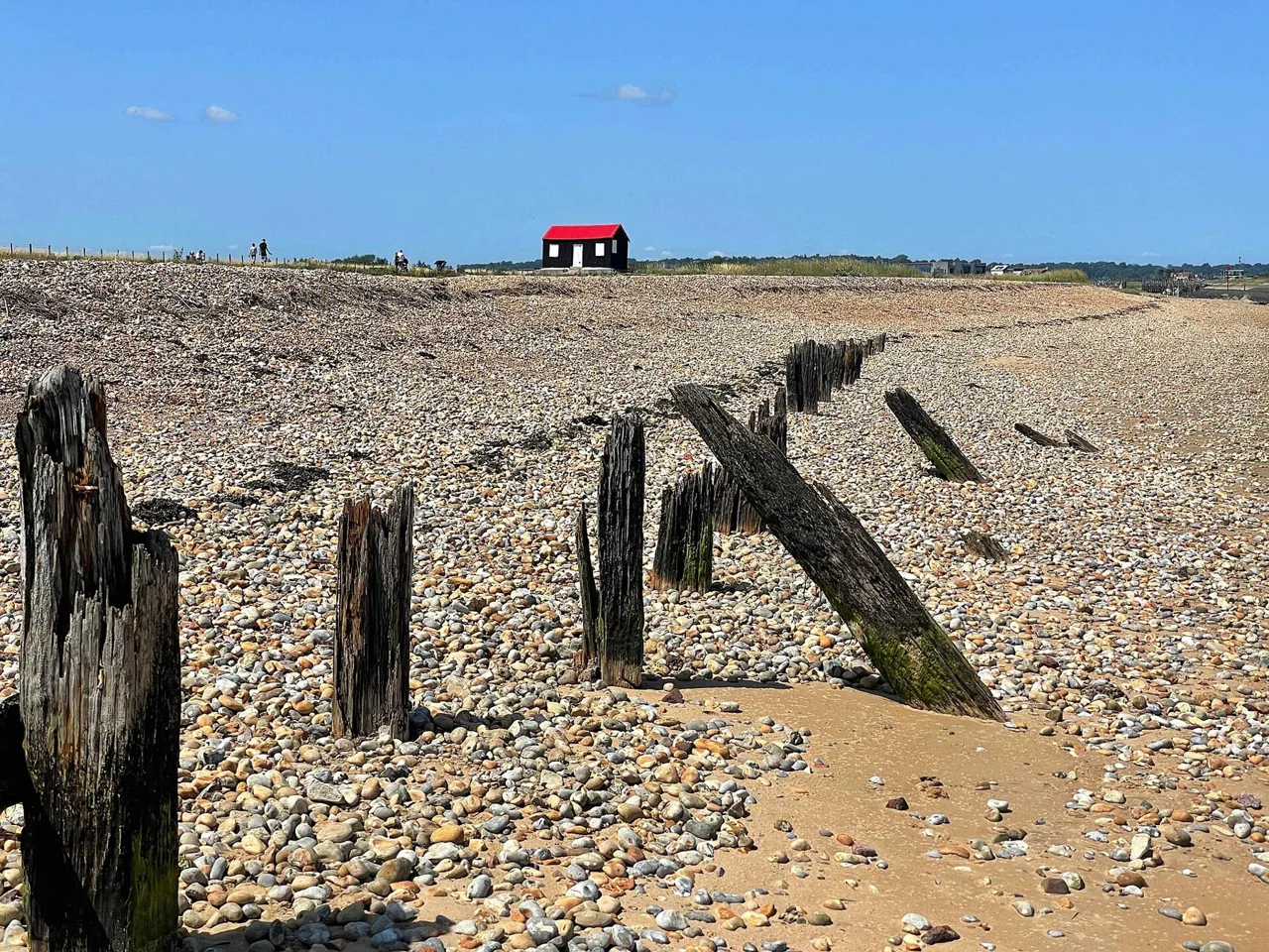 Shingle and the red-roofed hut at Rye Harbour Nature Reserve