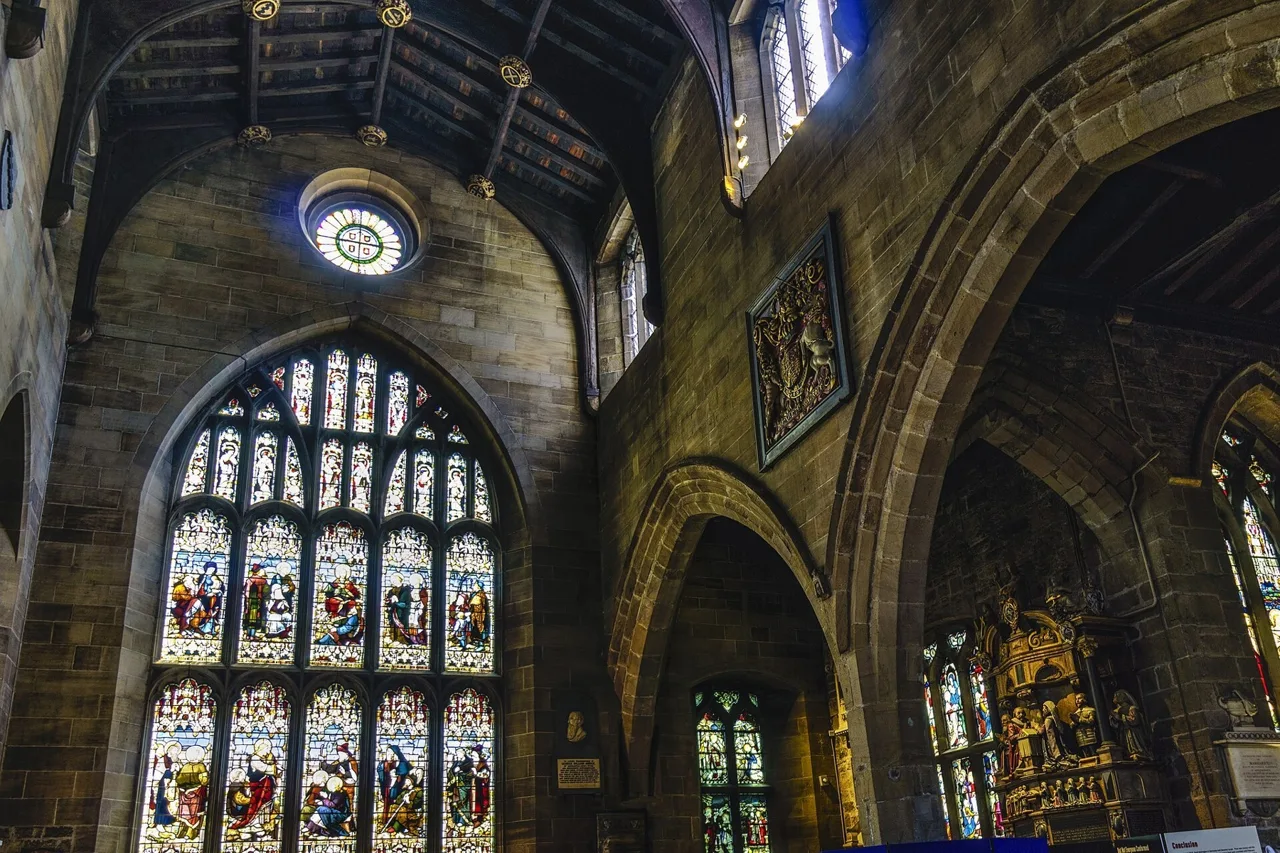 Stone arches and stained-glass windows inside Newcastle Cathedral