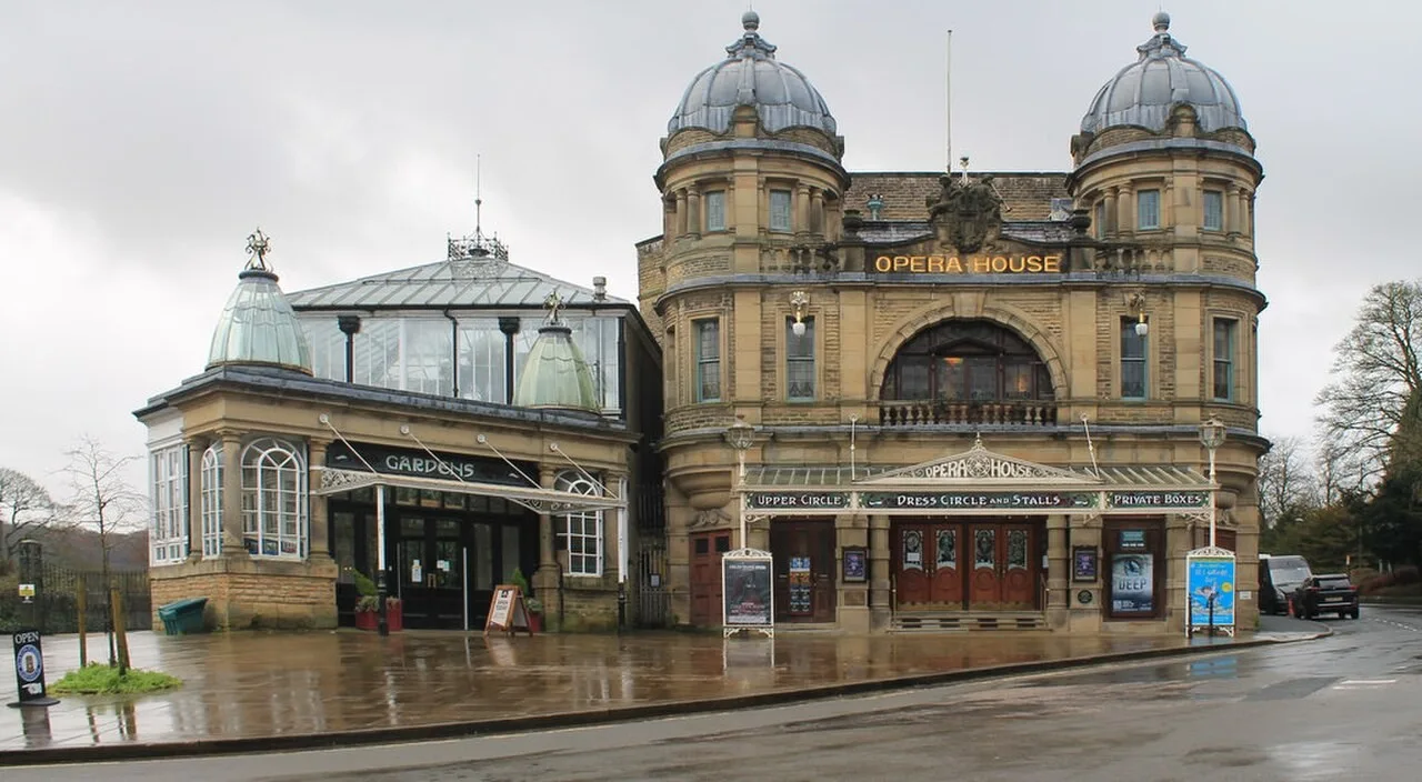 Twin-domed entrance of Buxton Opera House beside the Pavilion Gardens building