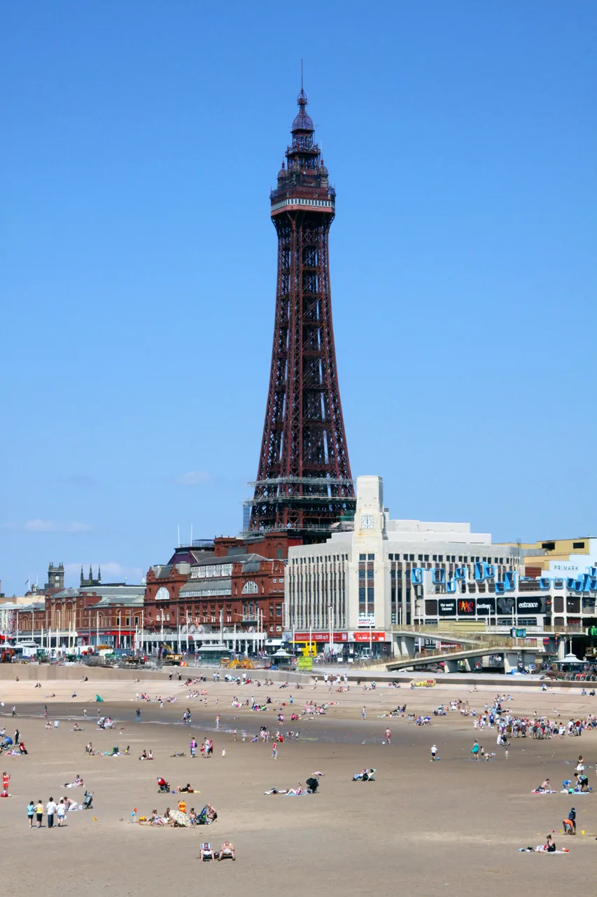 Blackpool Tower rising above the seafront and sandy beach