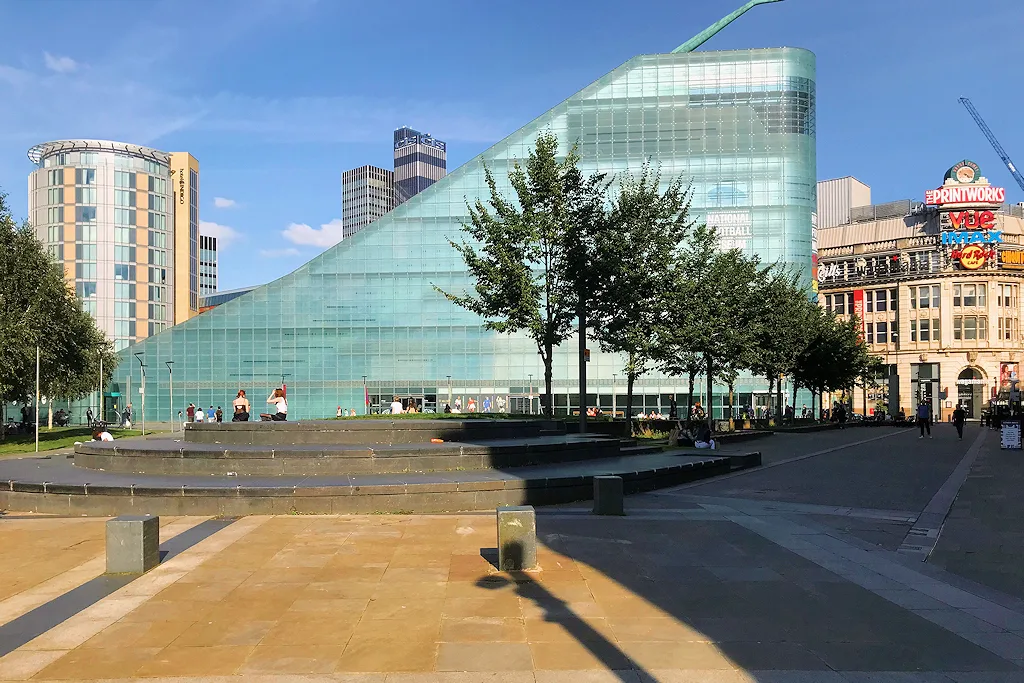The sloping glass Urbis building housing the National Football Museum above Cathedral Gardens