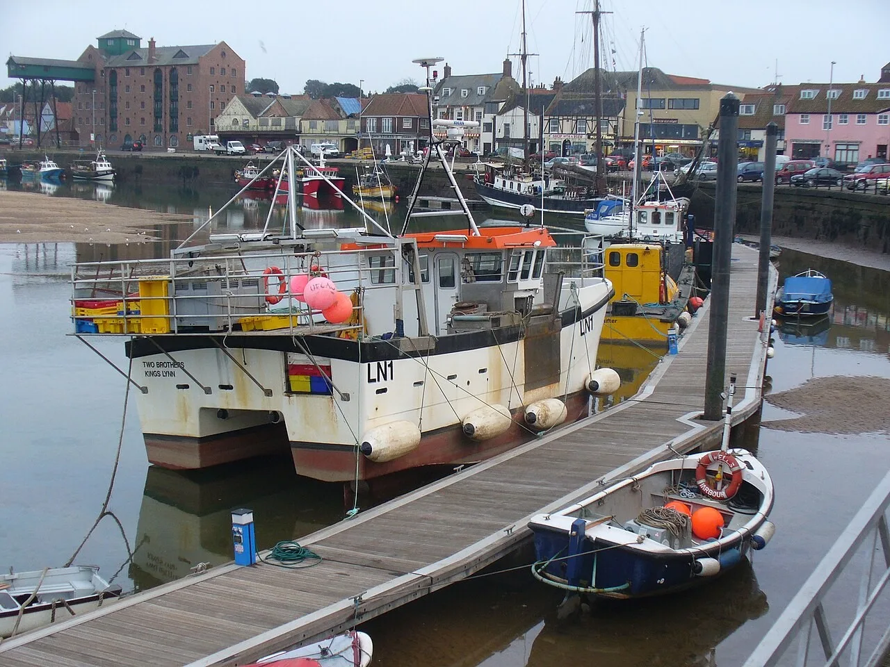 Fishing boats in Wells harbour with the town and granary beyond