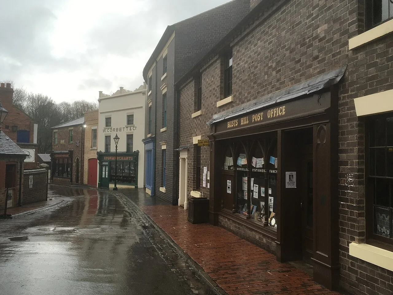 Historic shopfronts and a wet street at Blists Hill Victorian Town