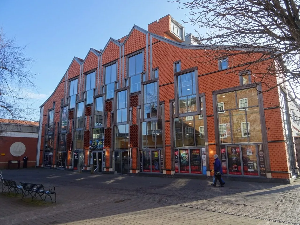 Red-brick and glass frontage of Lichfield Garrick Theatre beside Castle Dyke