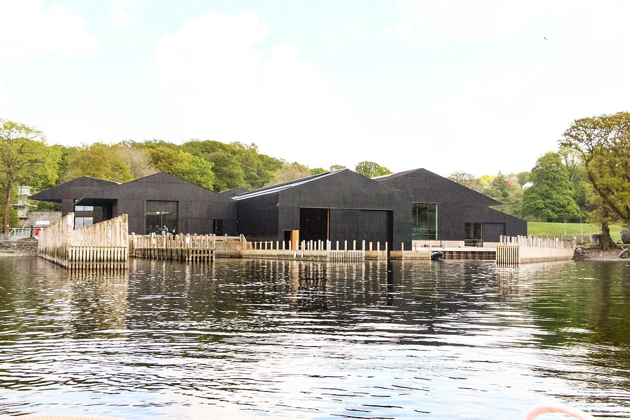 Dark timber museum buildings and jetties beside Windermere