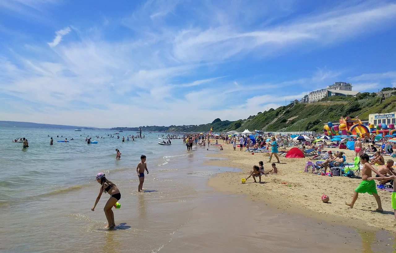 Visitors on Bournemouth’s sandy beach beneath the coastal cliffs