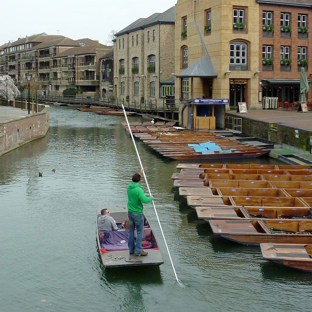 A punt passing moored boats at Scudamore’s Quayside station in Cambridge