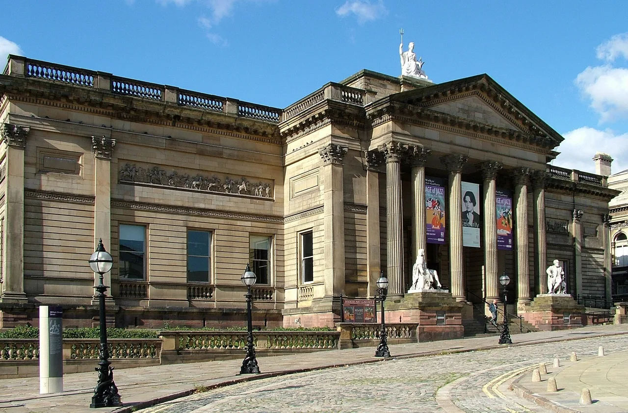The columned entrance and stone statues outside Walker Art Gallery
