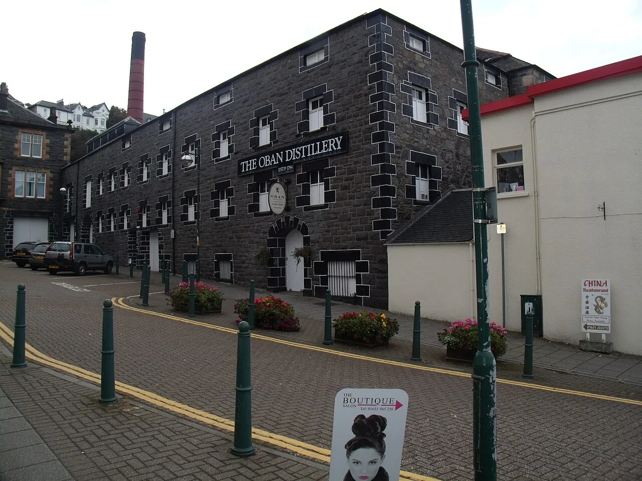 Stone facade and signed visitor entrance of Oban Distillery on Stafford Street