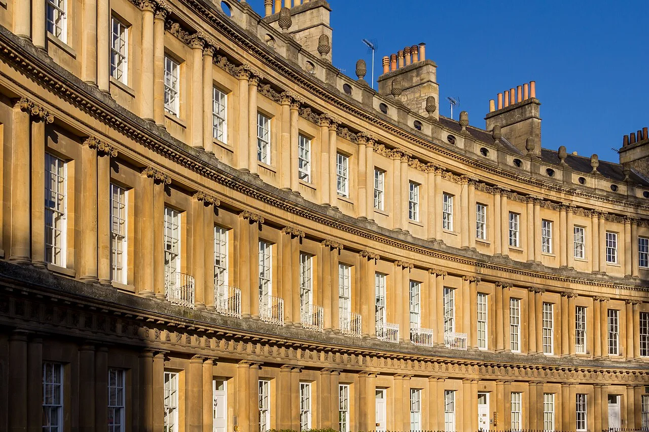 Sunlit Georgian façades following the curve of the Royal Crescent in Bath