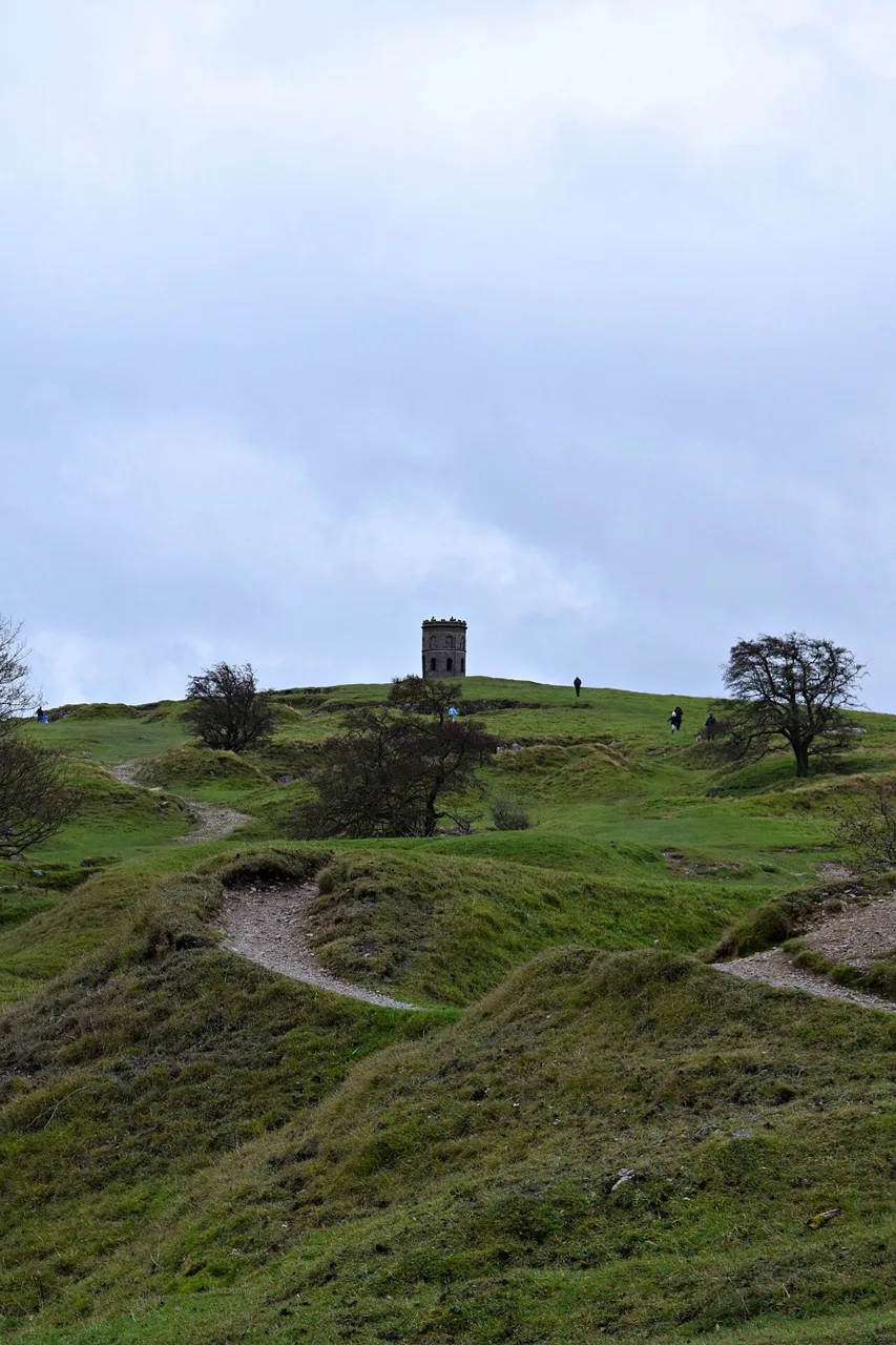 Solomon’s Temple folly above grassy slopes and paths on Grin Low