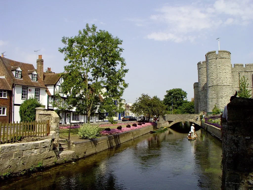 The River Stour and flower-lined banks beside Westgate Towers