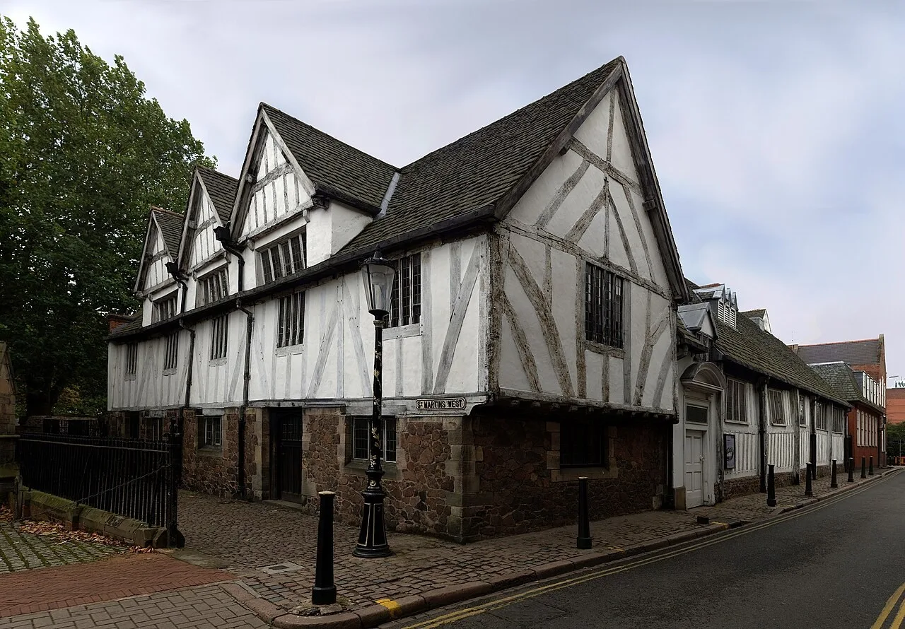 Timber-framed exterior of Leicester Guildhall beside the lane