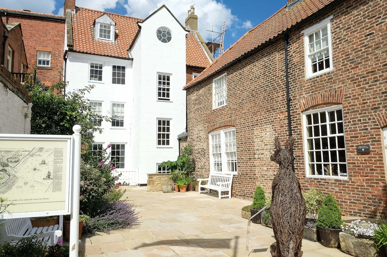 Brick and whitewashed buildings around the Captain Cook Memorial Museum courtyard