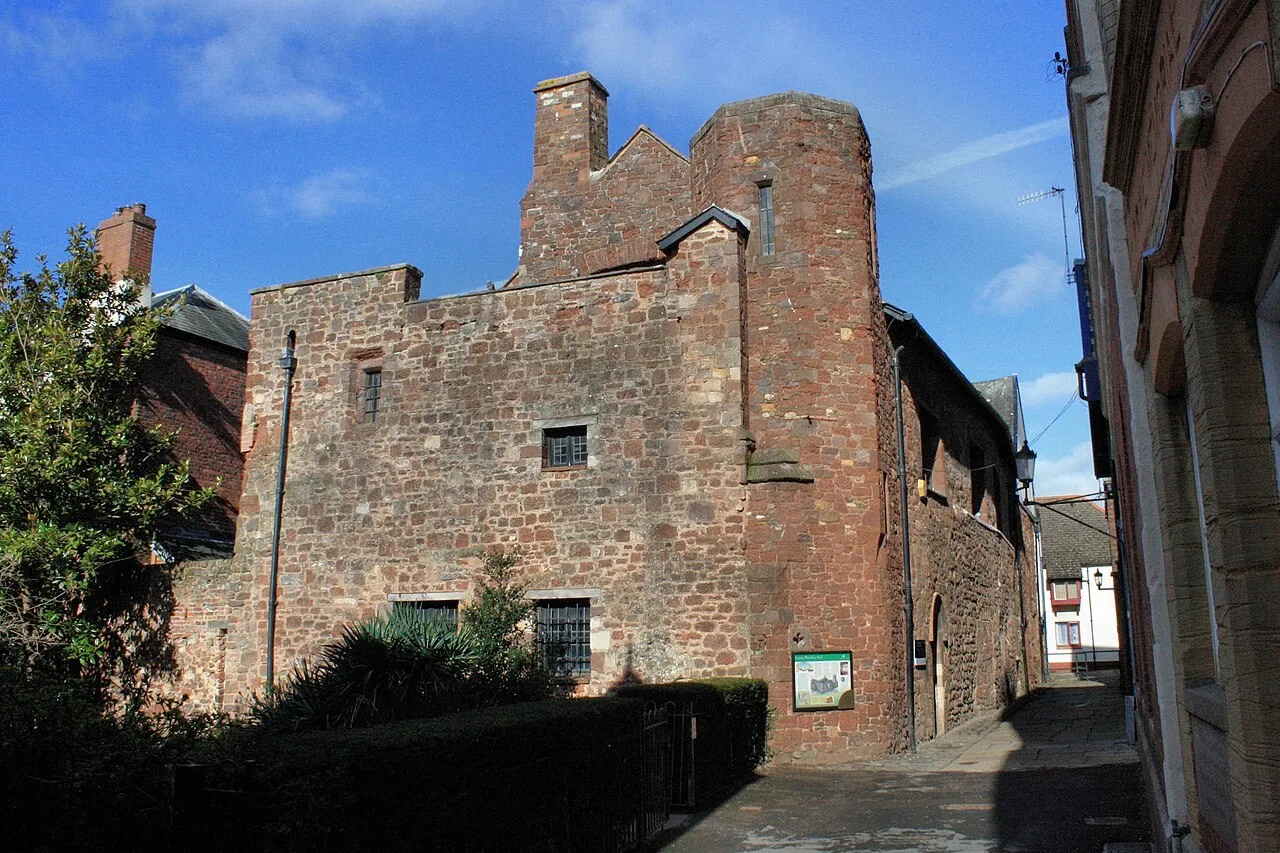 The stone exterior of St Nicholas Priory beside Mint Lane
