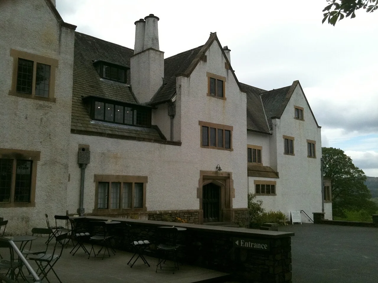 White-rendered Blackwell house with tall chimneys and projecting gables