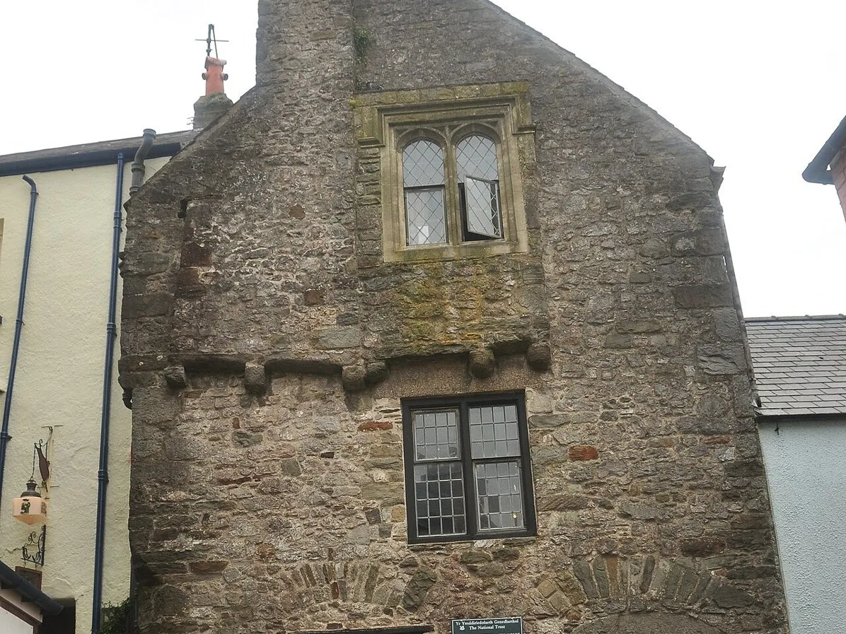 Stone facade and windows of the Tudor Merchant’s House in Tenby