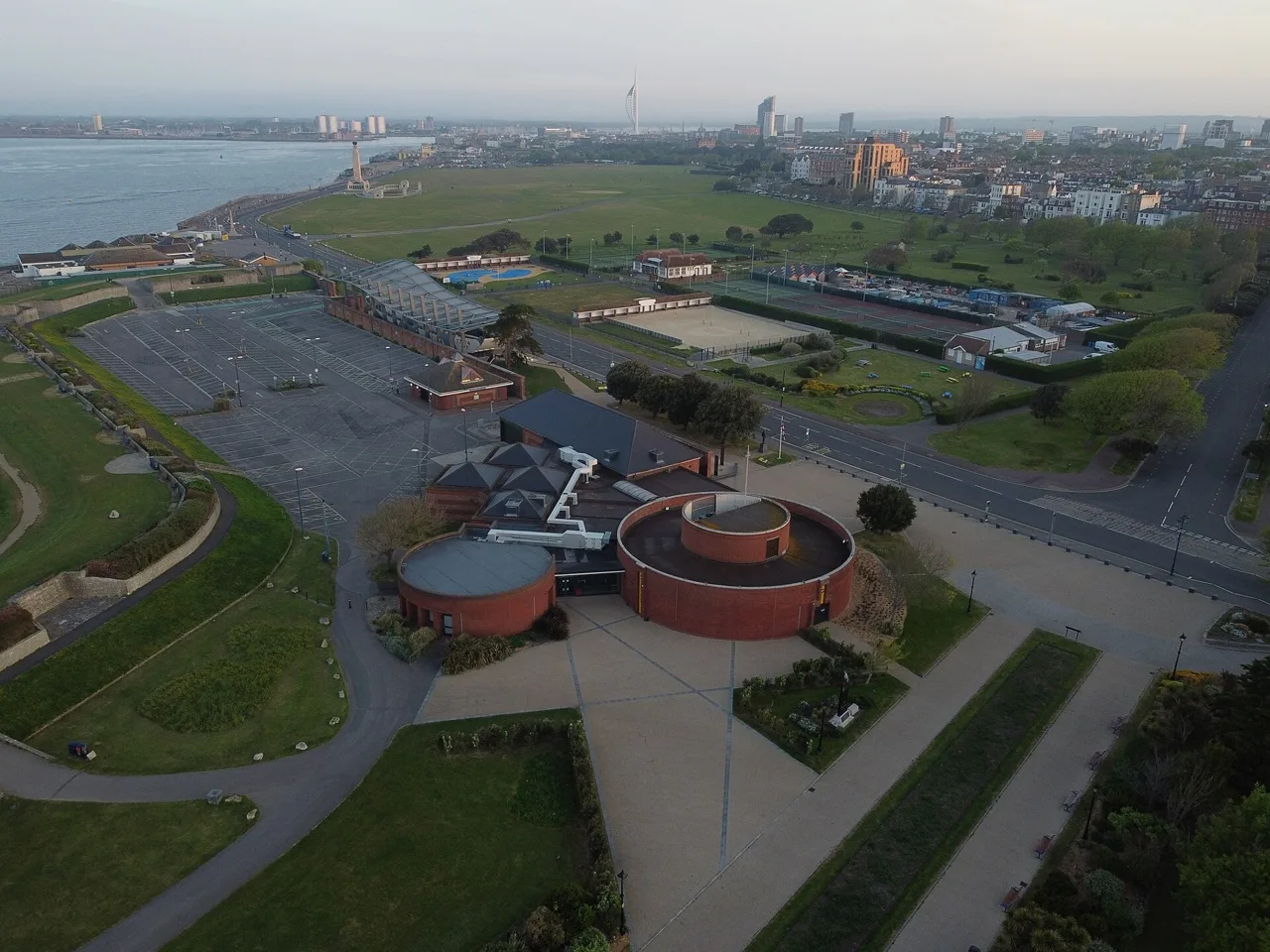 Aerial view of the circular D-Day Story museum buildings beside Southsea Common