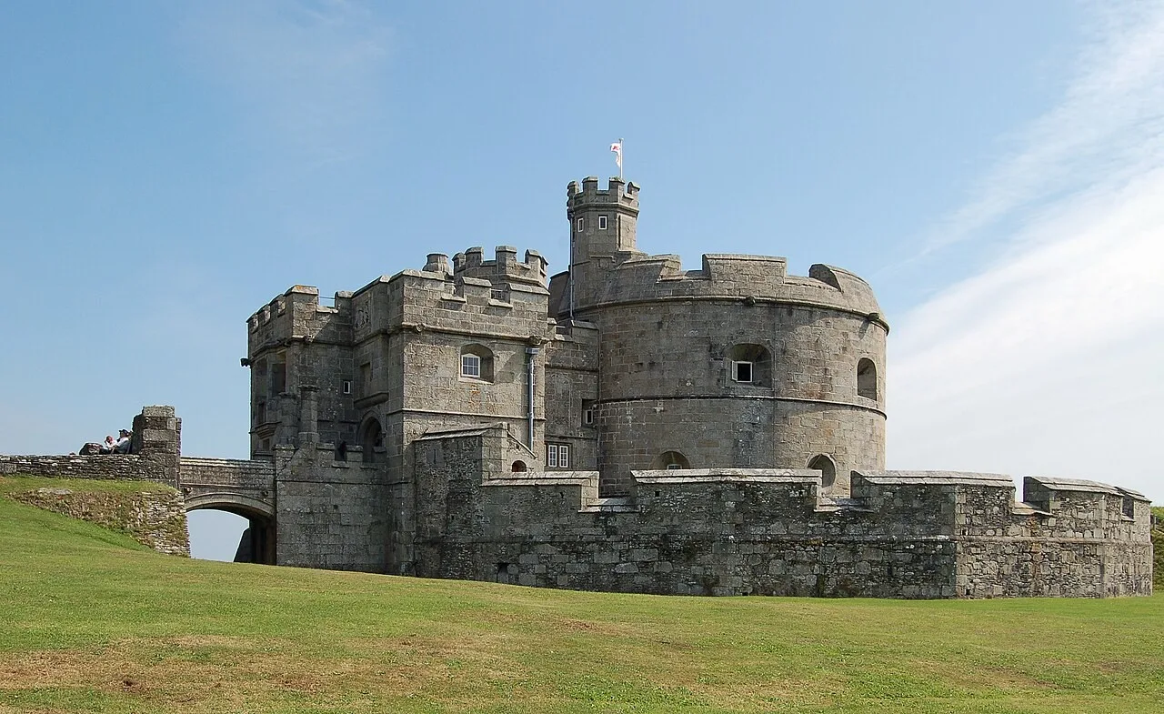 Round stone keep and battlements at Pendennis Castle above a grassy foreground