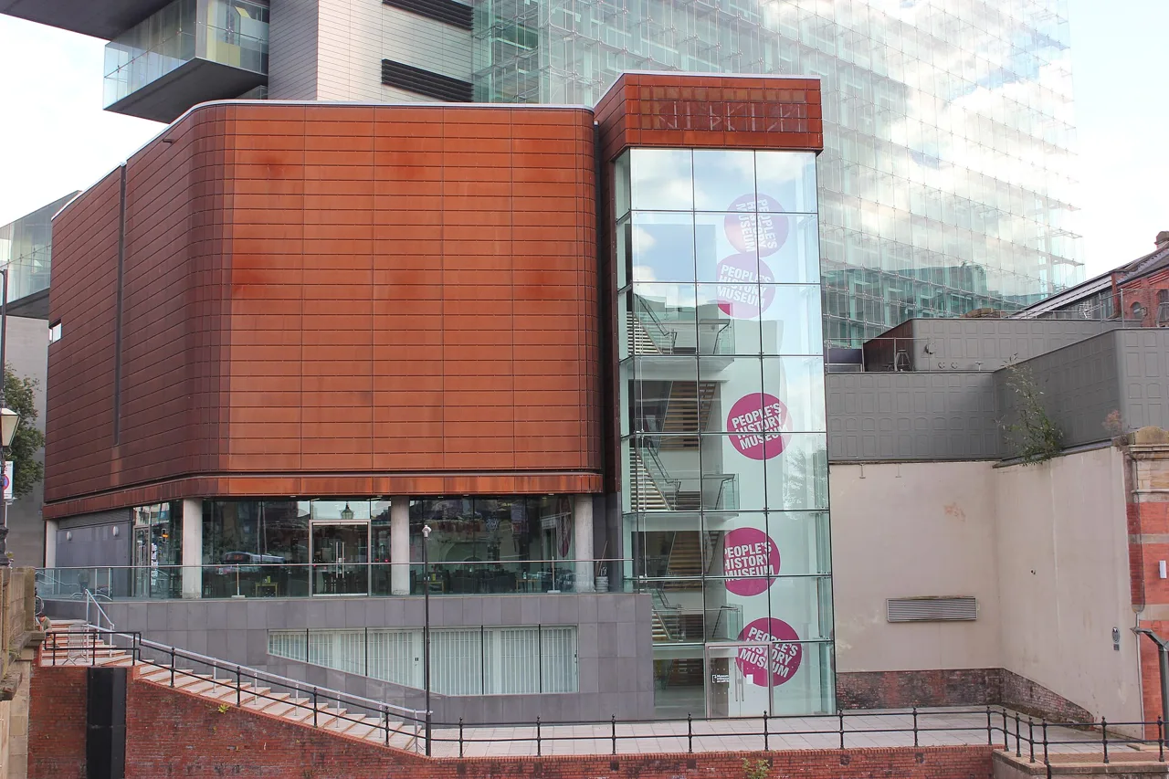 Glass and rust-coloured exterior of People’s History Museum beside the Irwell