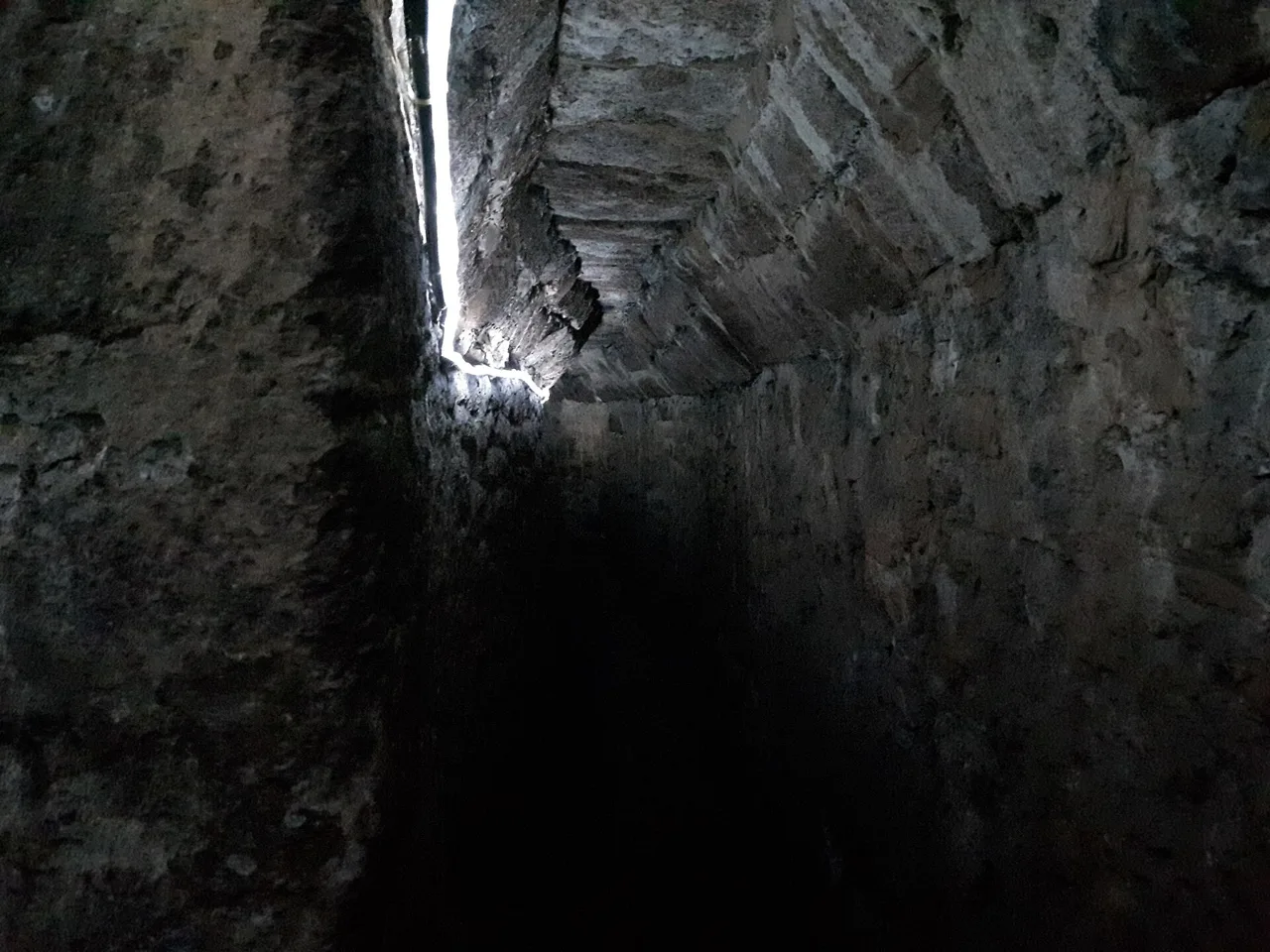 A narrow stone-lined tunnel inside Exeter’s Underground Passages