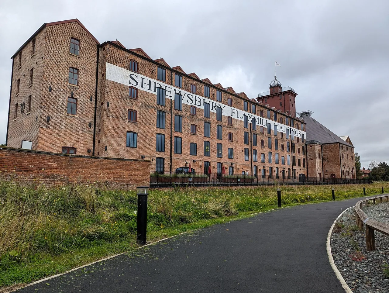 Restored brick Flaxmill building beside a public approach path
