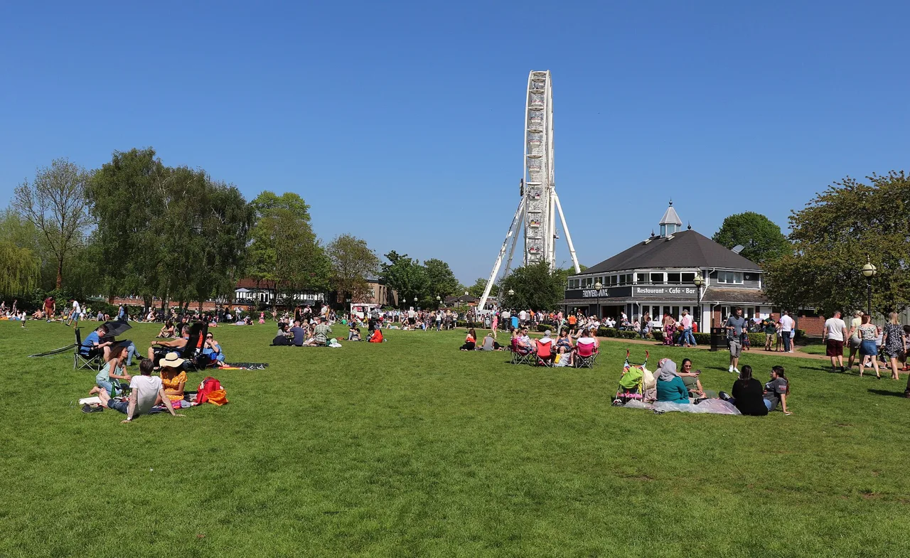 Visitors picnicking on the lawns of Stratford Recreation Ground