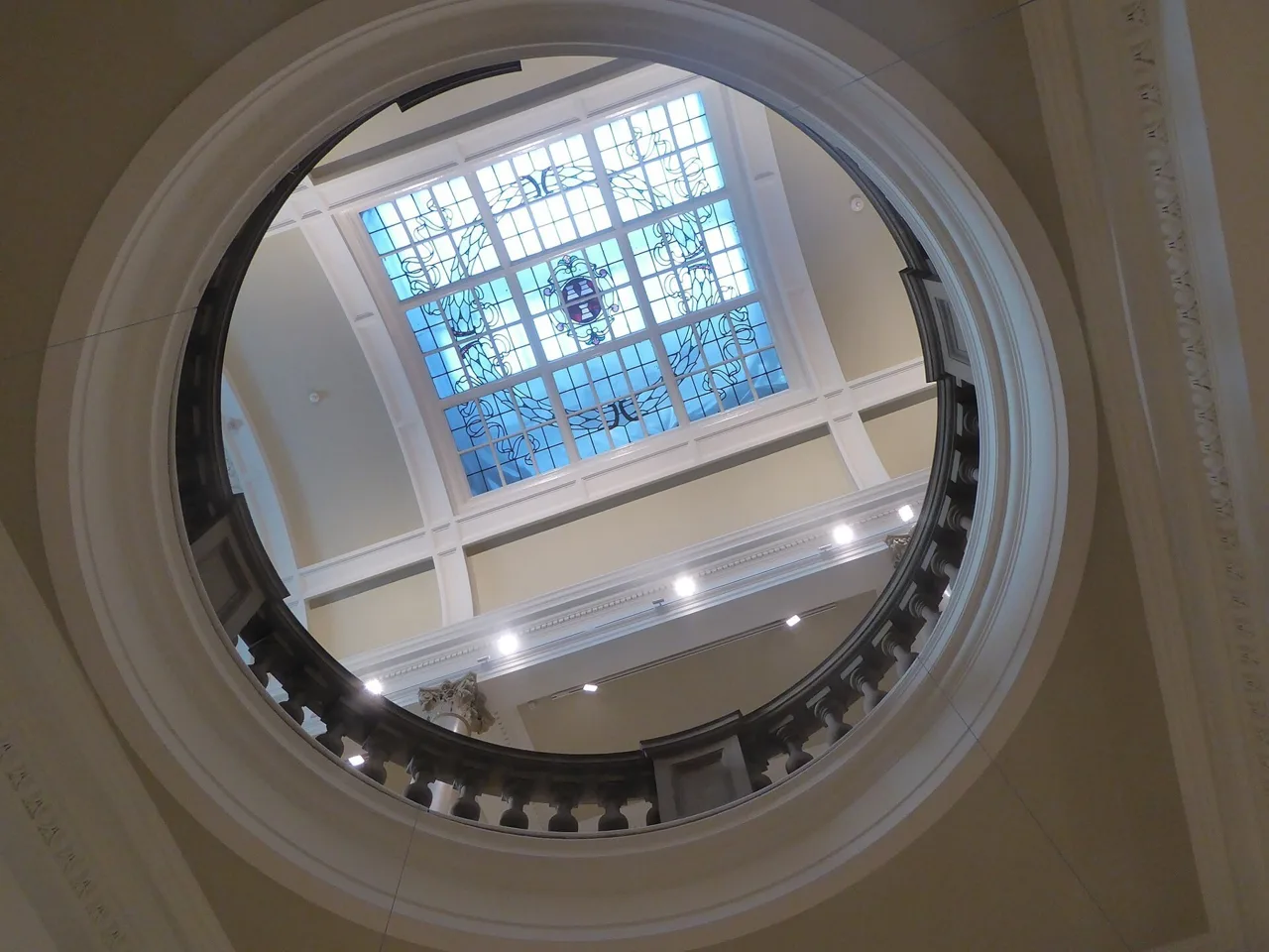 Looking up through the circular stairwell towards stained glass inside Laing Art Gallery