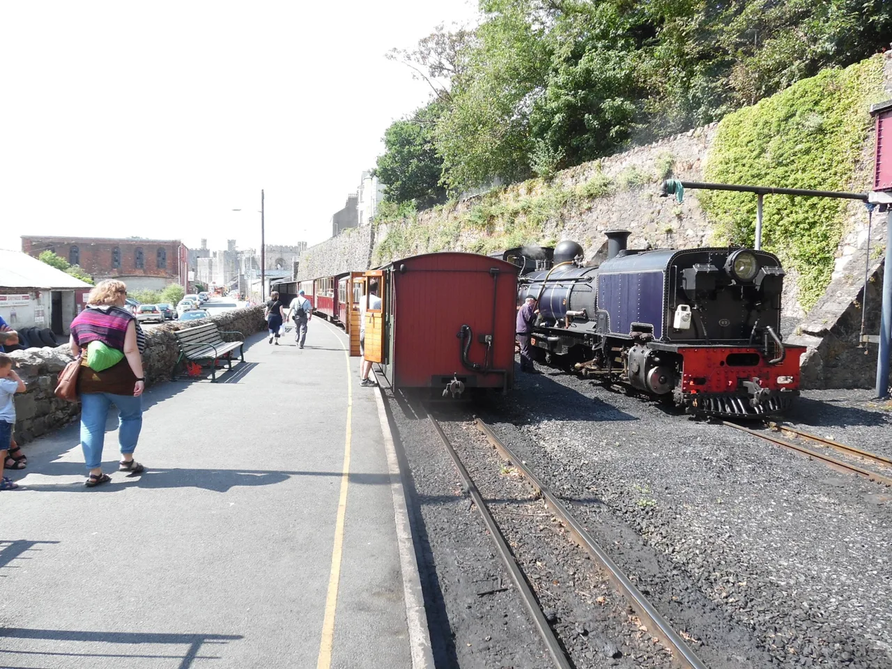A Welsh Highland Railway steam train beside the platform at Caernarfon