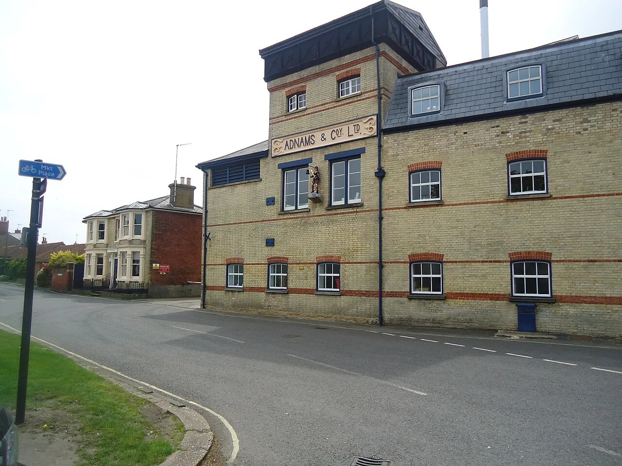 Adnams brewery building and sign beside a Southwold street