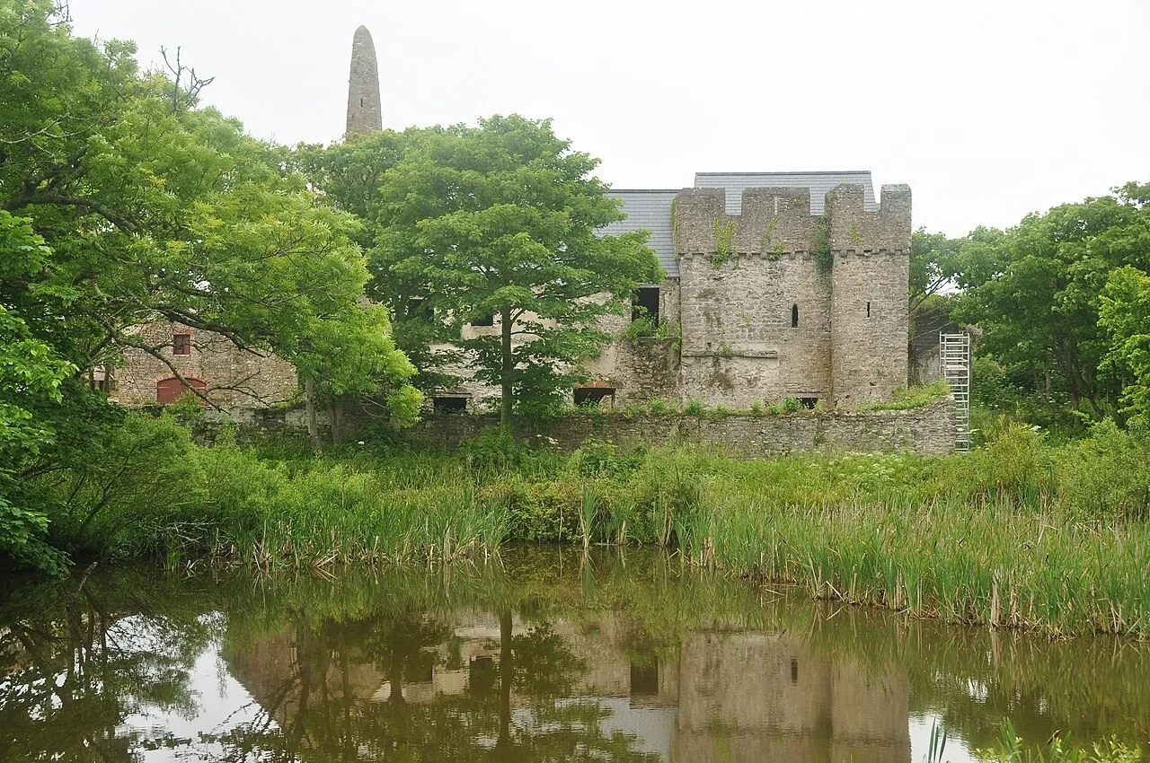Historic stone buildings beside a pond on Caldey Island