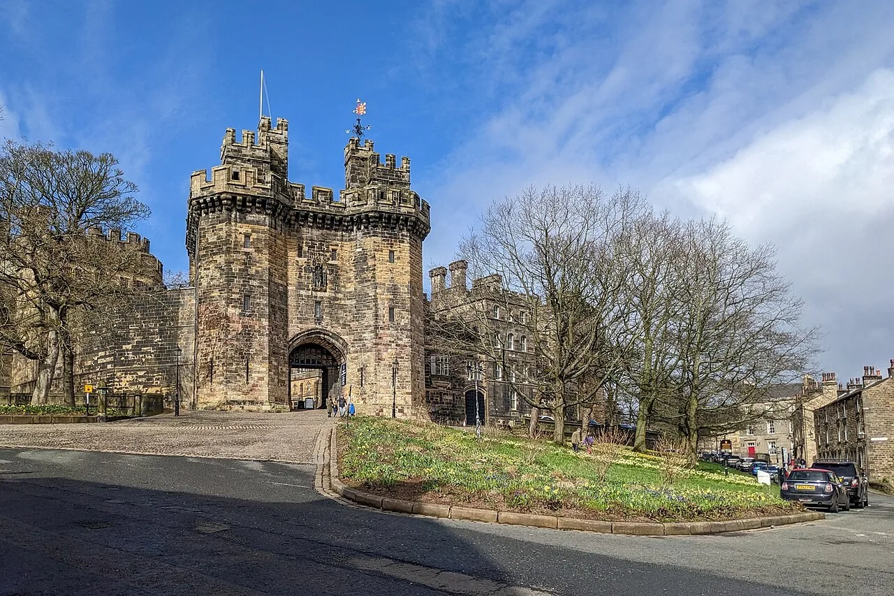 Stone towers of Lancaster Castle’s main gate beside the uphill approach