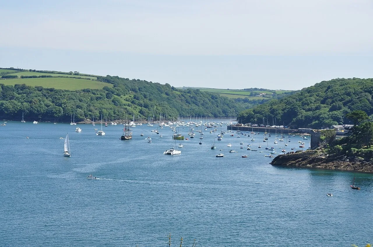 Boats on the Fowey estuary with wooded hills beyond