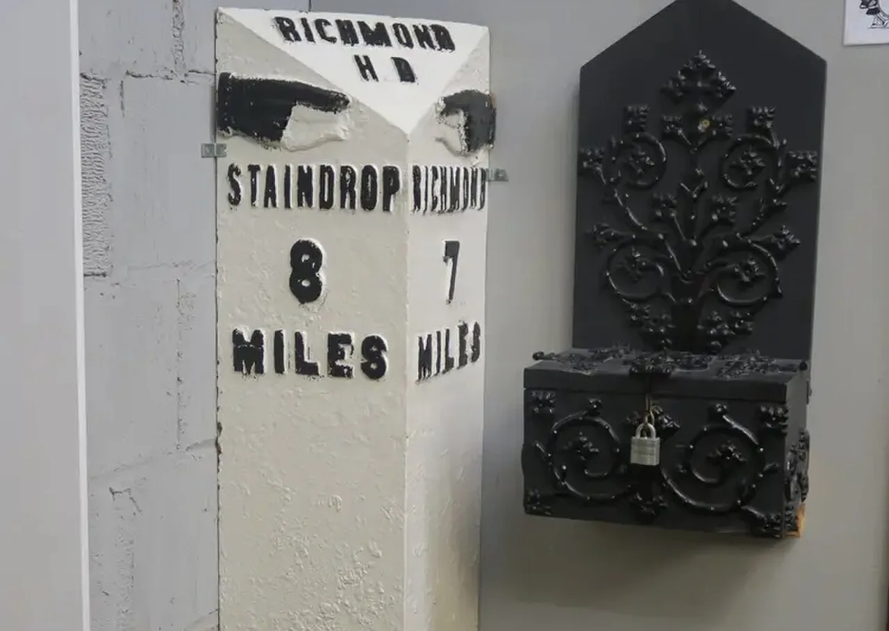 Old Richmond and Staindrop milepost displayed with historic metalwork at Richmondshire Museum