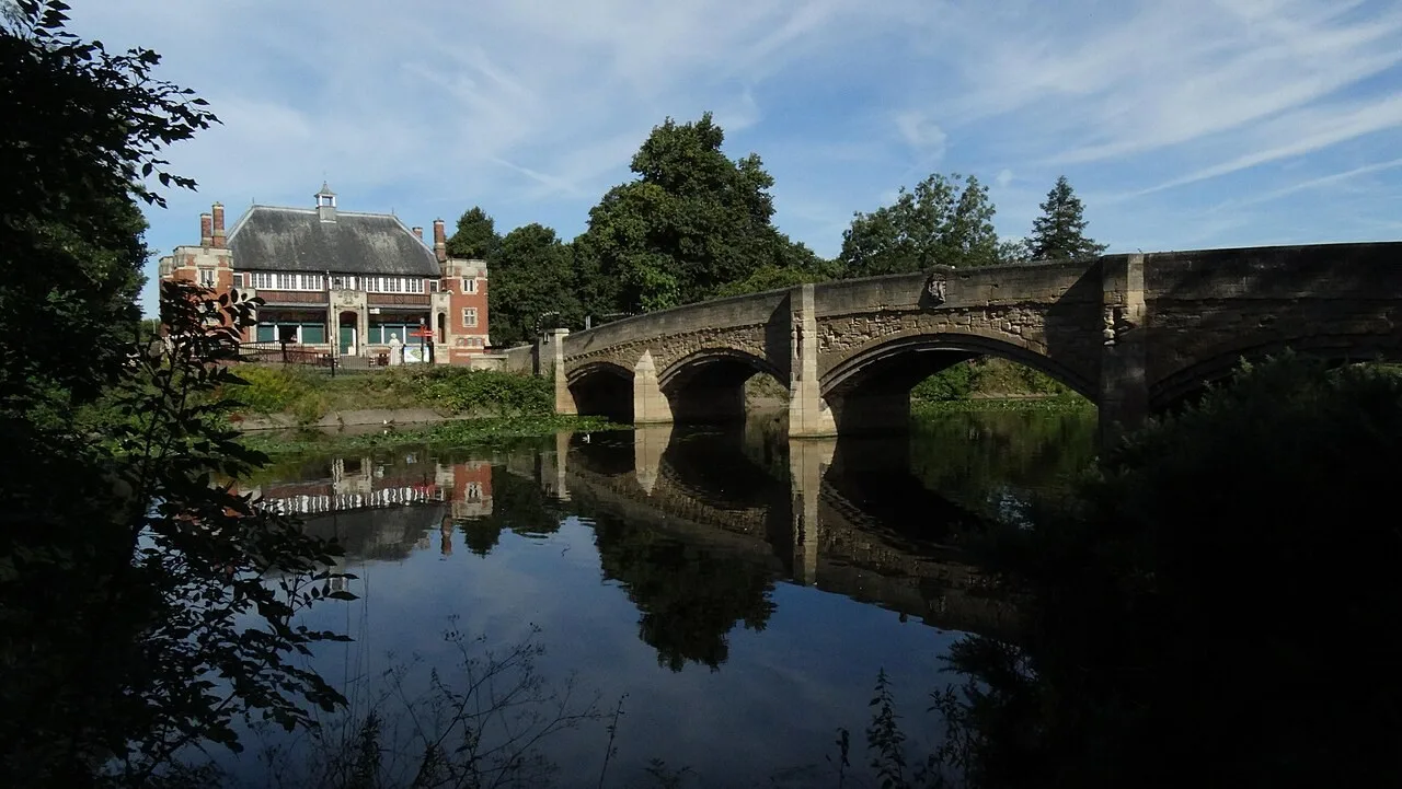 Stone bridge reflected in the River Soar at Abbey Park