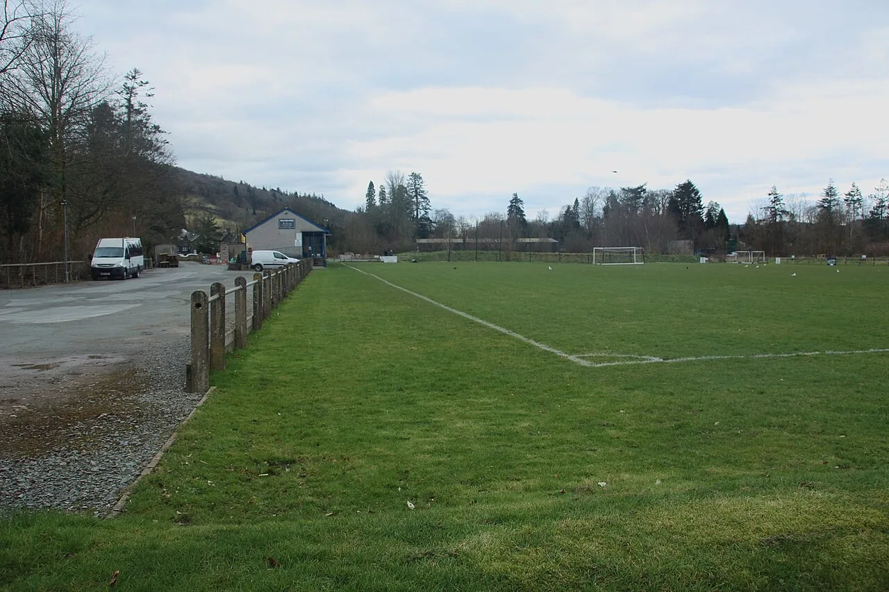 Grass football pitch and paths in Rothay Park with hills beyond