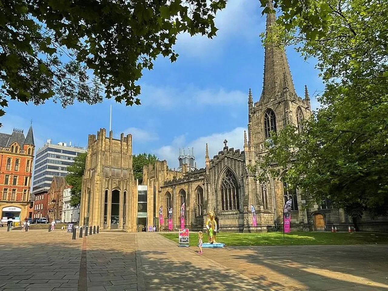 Sheffield Cathedral and its stone forecourt framed by trees