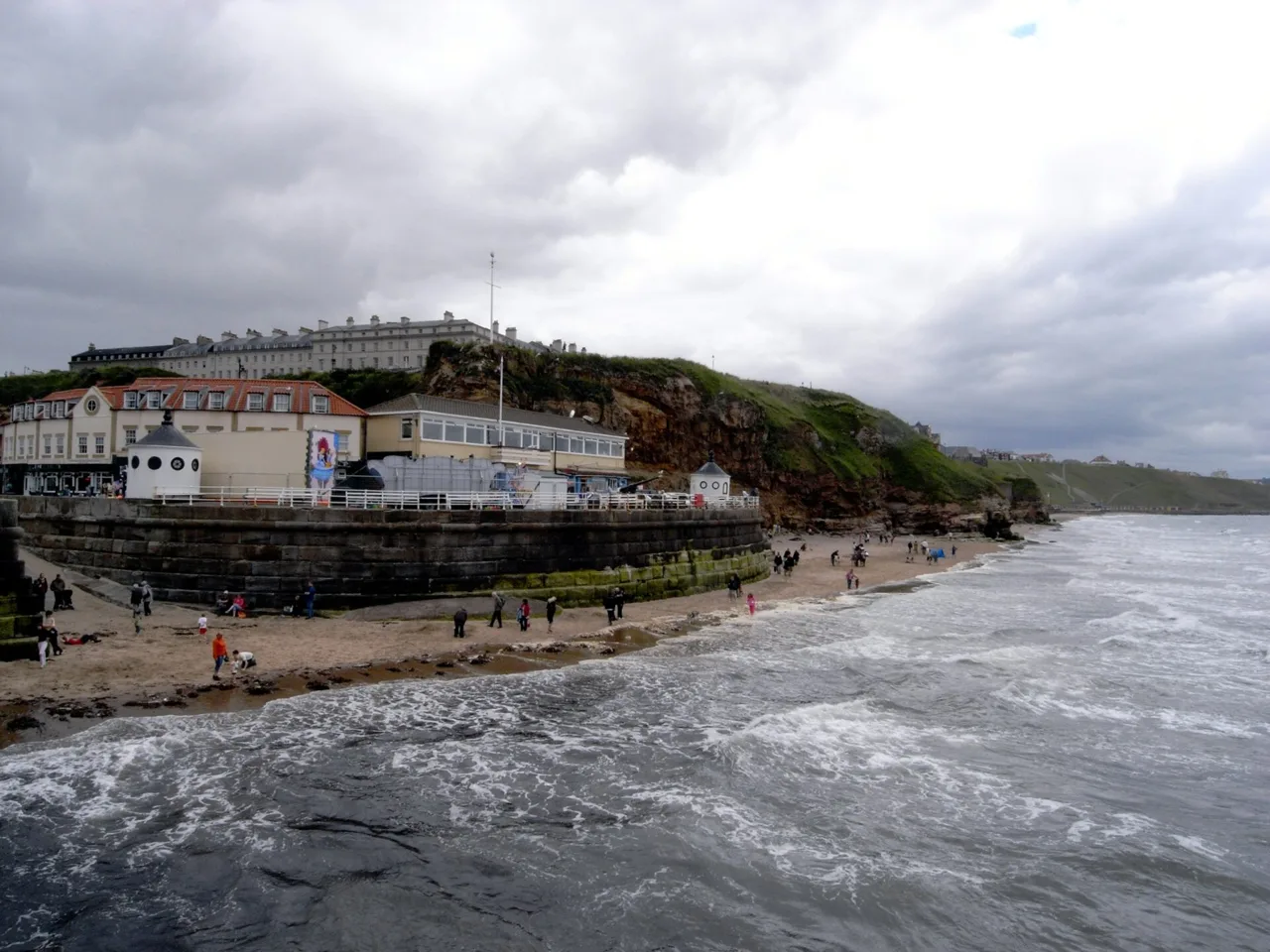 Waves meeting the sands below Whitby’s West Cliff, seen from West Pier