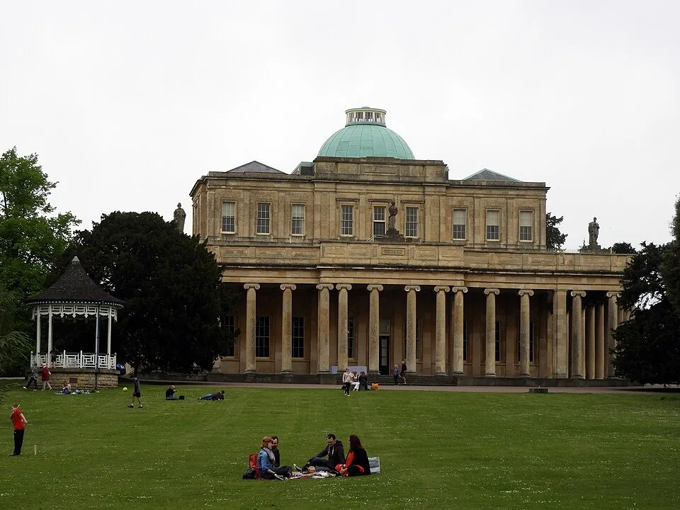 Pittville Pump Room and colonnade above its park lawn