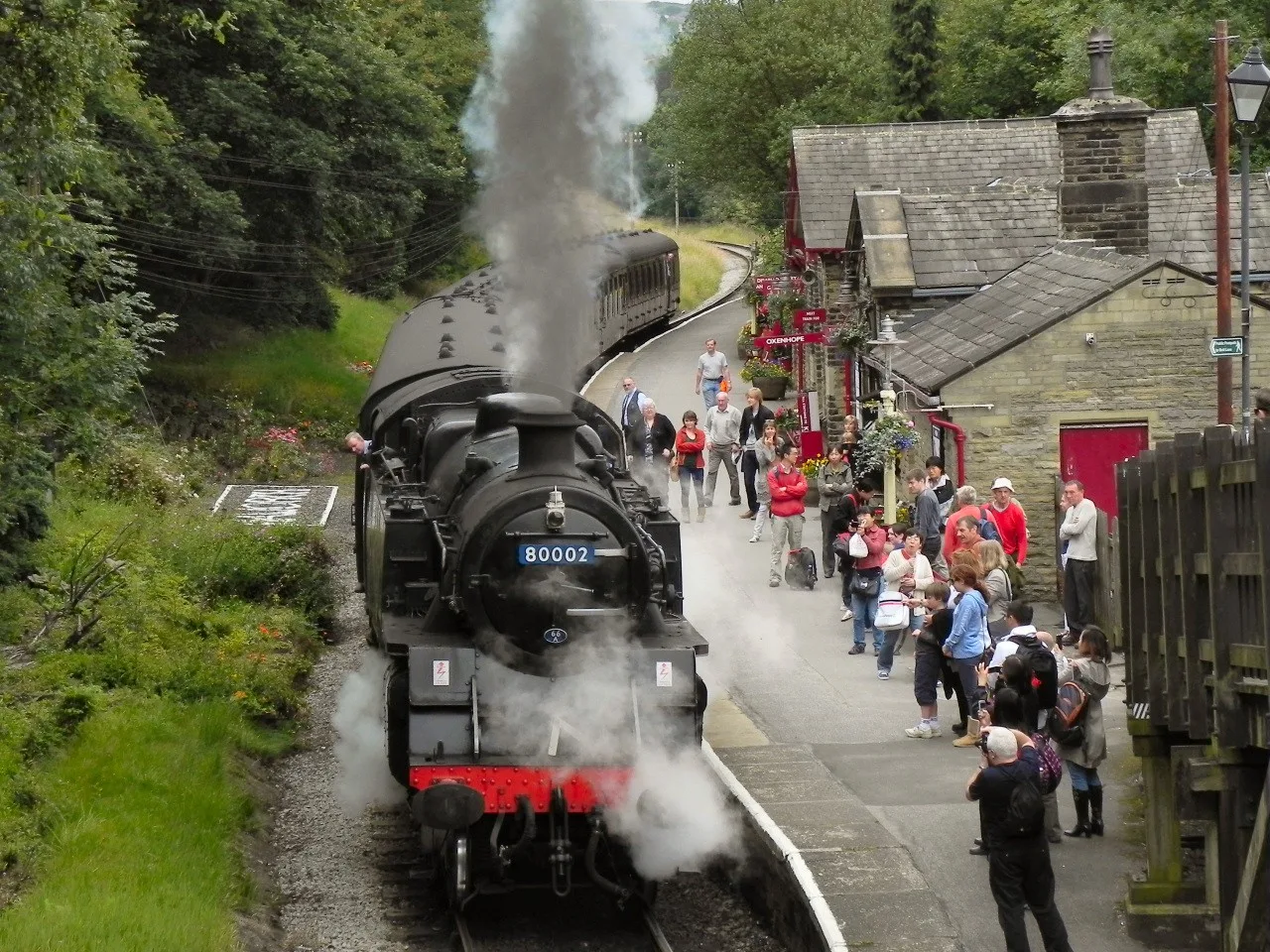 Steam train beside Haworth station platform