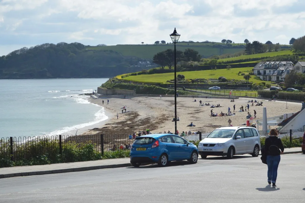 Sandy curve of Gyllyngvase Beach and the bay seen from Cliff Road