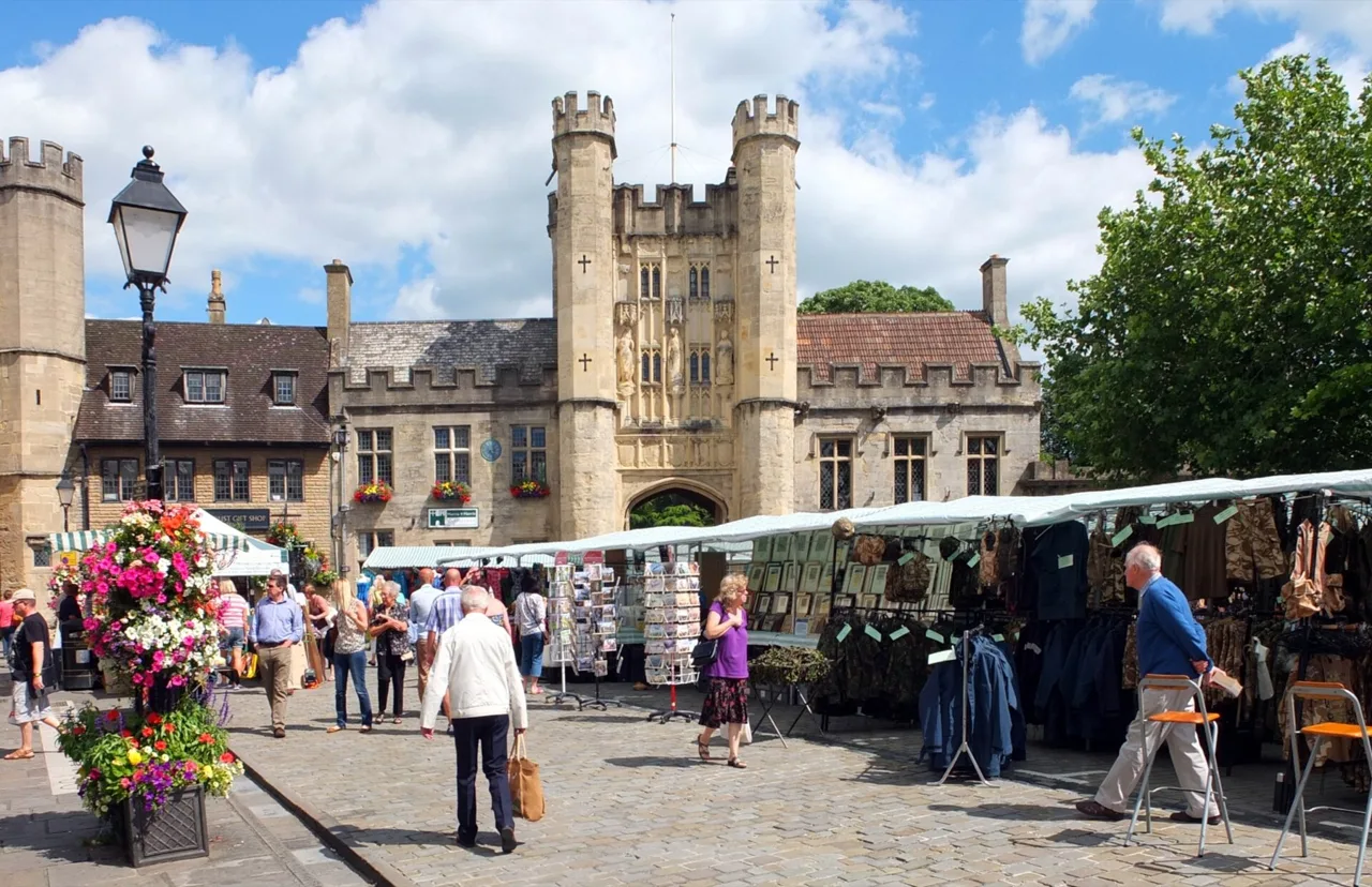 Market stalls and shoppers in Wells Market Place