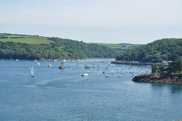 Boats on the Fowey estuary with wooded hills beyond